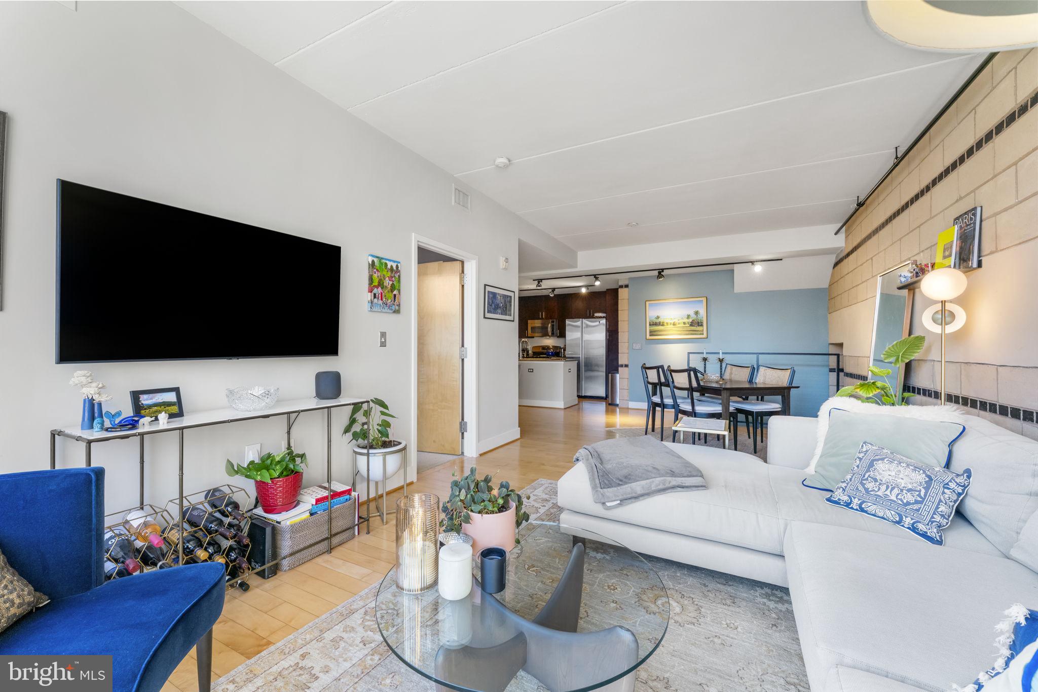 1529 14th Street Northwest, Unit 309 Washington, DC 20005 - Photo 9 of 21 a living room with furniture and a flat screen tv