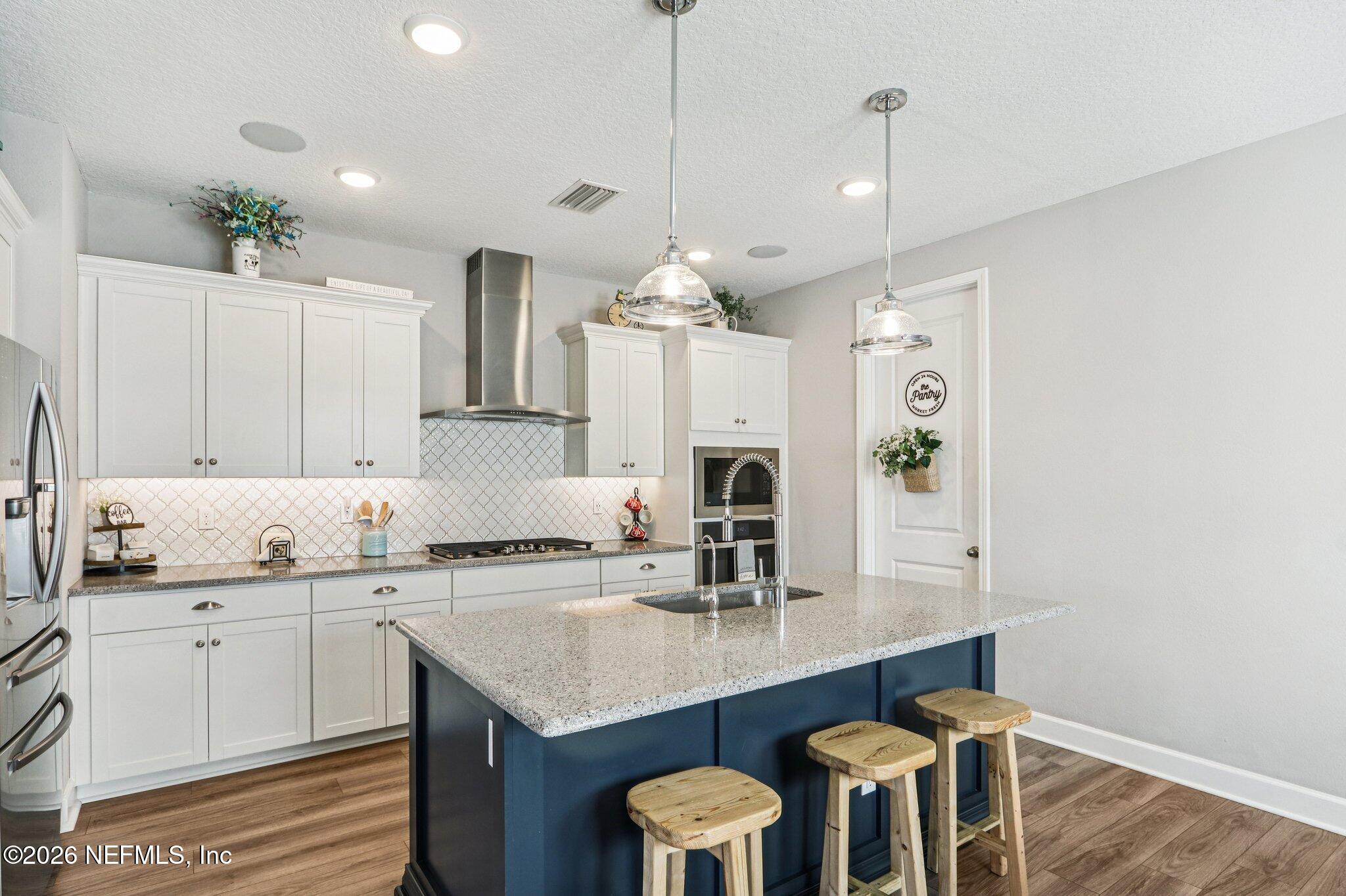 73 Andesite Trail Ponte Vedra, FL 32081 - Photo 14 of 42 a kitchen with granite countertop a sink a center island and cabinets