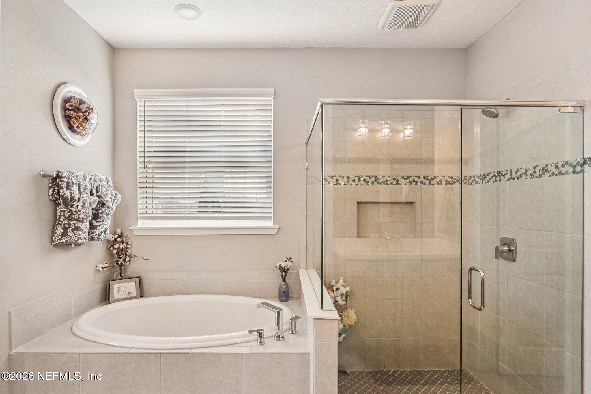 73 Andesite Trail Ponte Vedra, FL 32081 - Photo 20 of 42 a bathroom with a bathtub a shower and a window