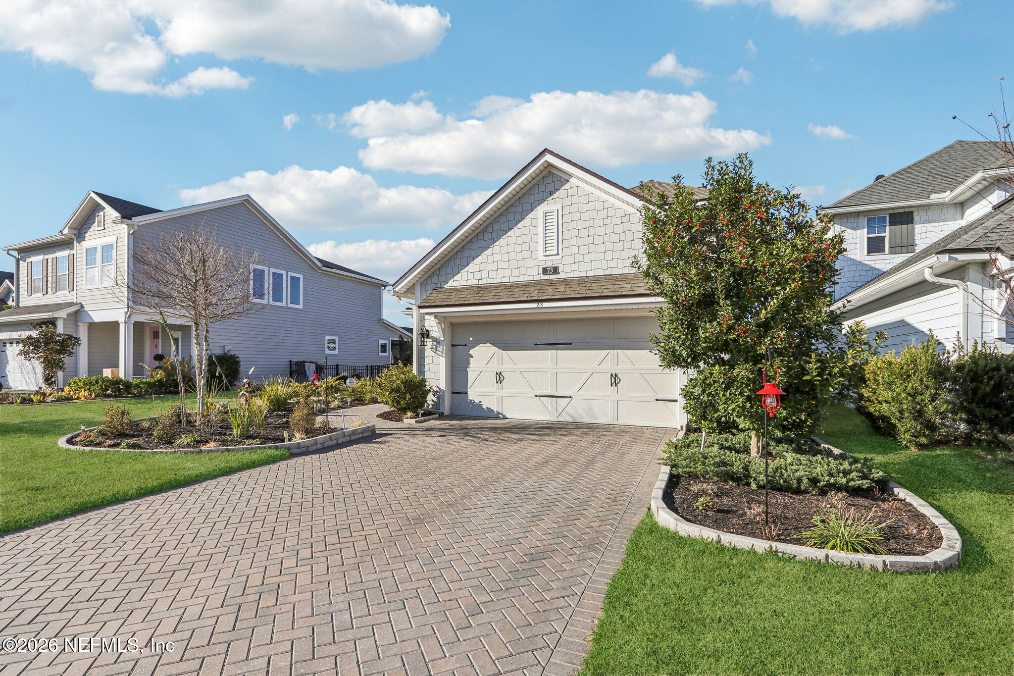 73 Andesite Trail Ponte Vedra, FL 32081 - Photo 2 of 42 a front view of a house with a yard and garage