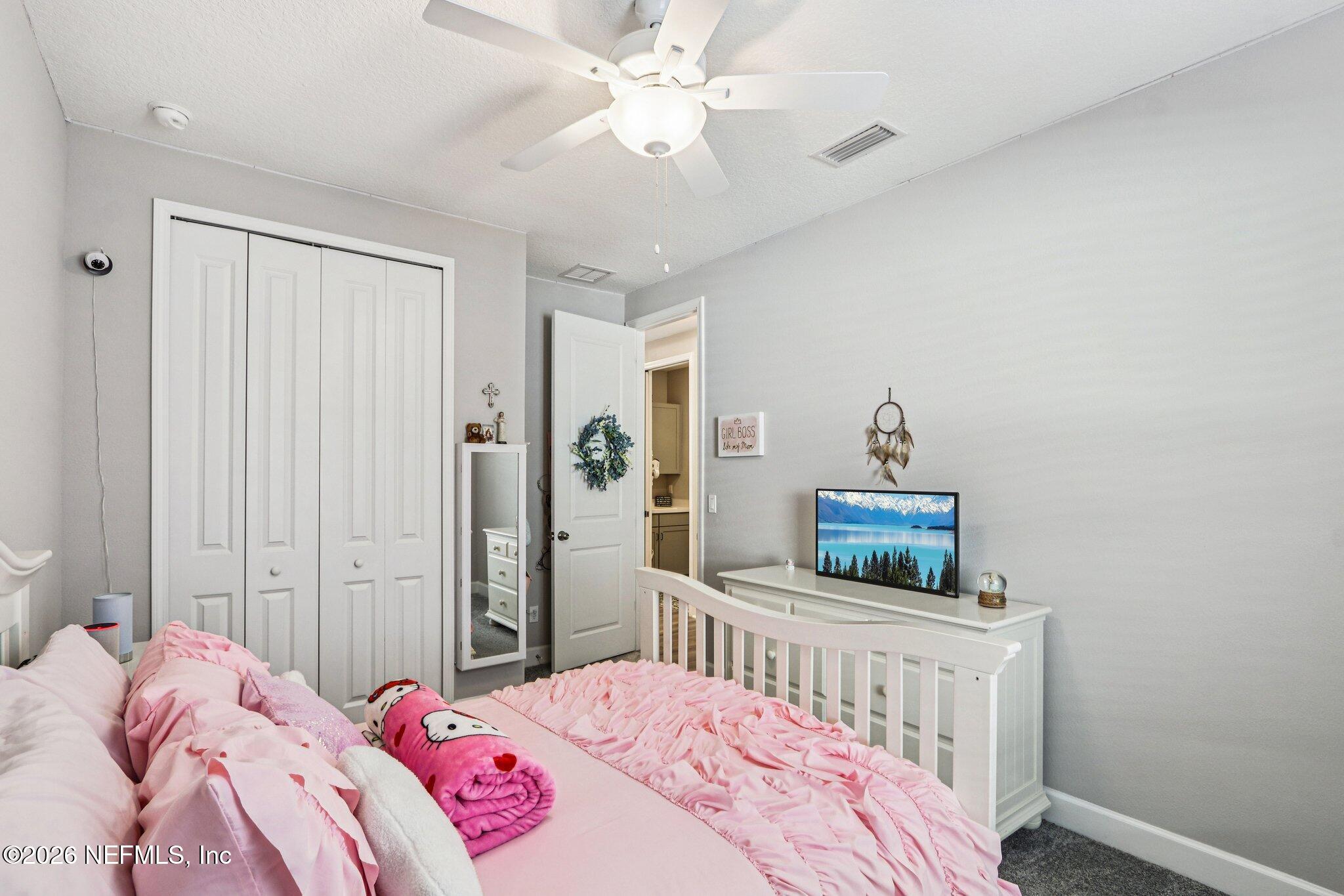 73 Andesite Trail Ponte Vedra, FL 32081 - Photo 26 of 42 a bedroom with a bed and a chandelier