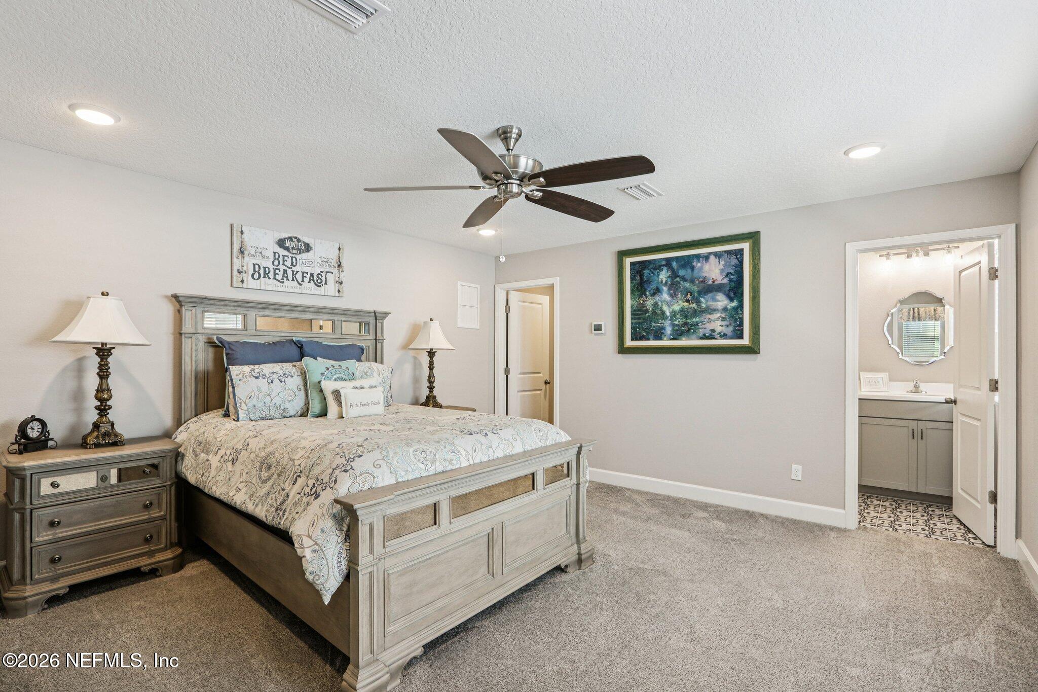 73 Andesite Trail Ponte Vedra, FL 32081 - Photo 27 of 42 a bedroom with a bed and a chandelier