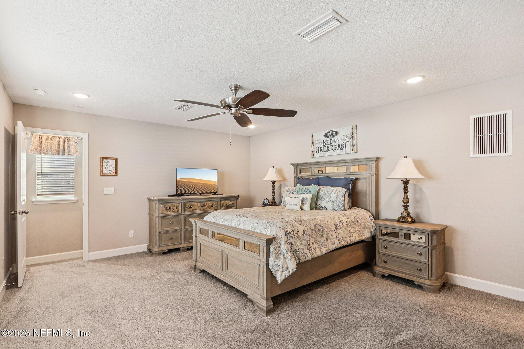73 Andesite Trail Ponte Vedra, FL 32081 - Photo 28 of 42 a bedroom with a bed and ceiling fan