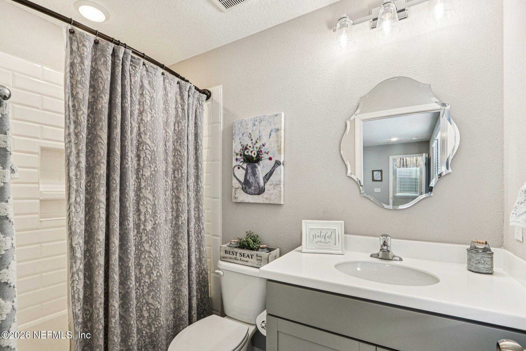 73 Andesite Trail Ponte Vedra, FL 32081 - Photo 30 of 42 a bathroom with a toilet a sink and mirror