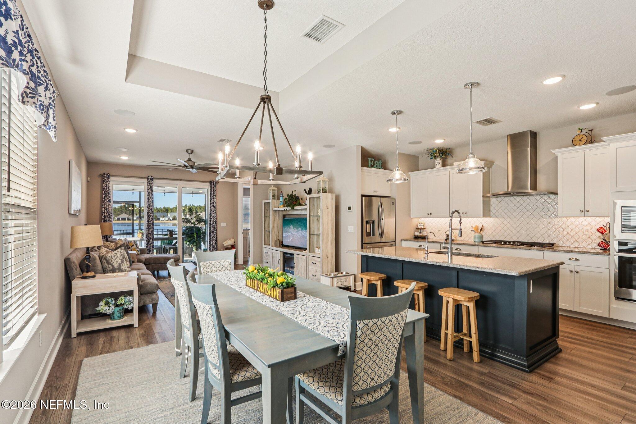 73 Andesite Trail Ponte Vedra, FL 32081 - Photo 5 of 42 a view of a dining room and livingroom with furniture wooden floor kitchen chandelier