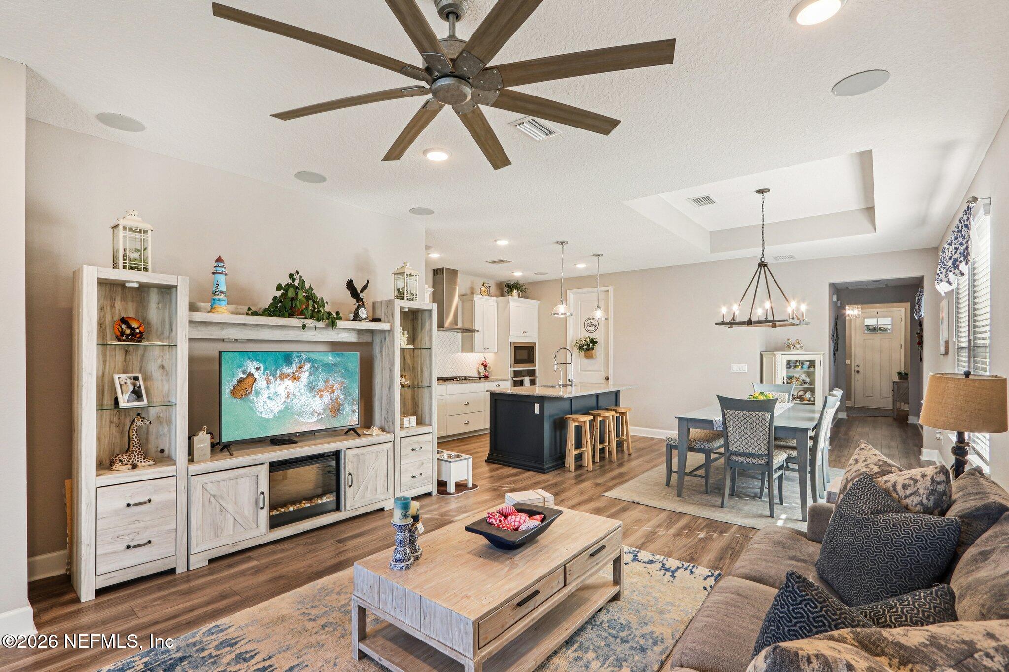 73 Andesite Trail Ponte Vedra, FL 32081 - Photo 7 of 42 a living room with furniture a flat screen tv and a dining table