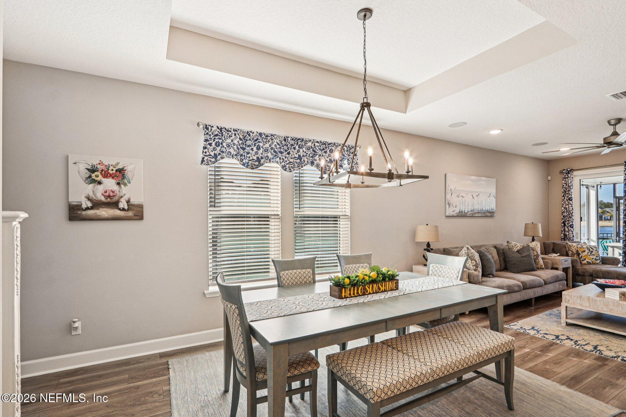73 Andesite Trail Ponte Vedra, FL 32081 - Photo 10 of 42 a living room with dining table and a chandelier