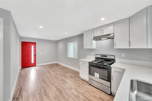 a kitchen with granite countertop a stove and a refrigerator