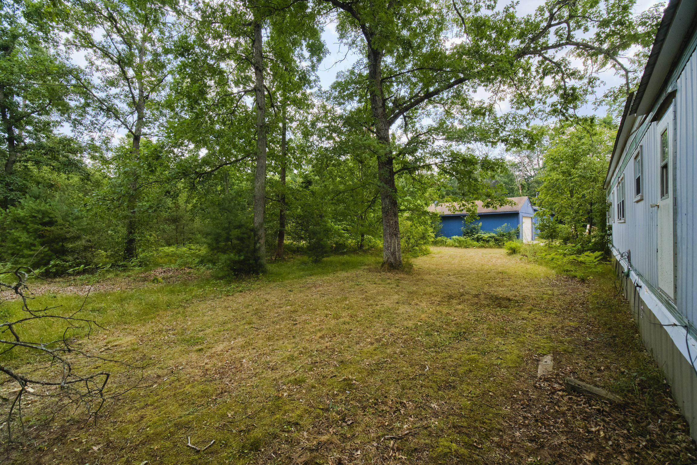 925 South High Bridge Road Wellston, MI 49689 - Photo 51 of 55 Backyard of mobile home