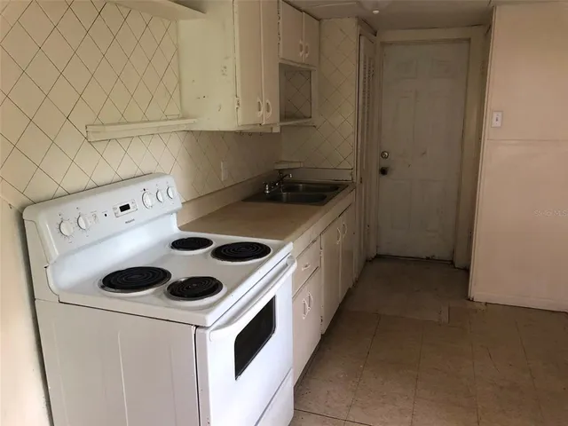 a kitchen with a cabinets and white appliances
