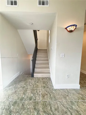 a view of a hallway with staircase