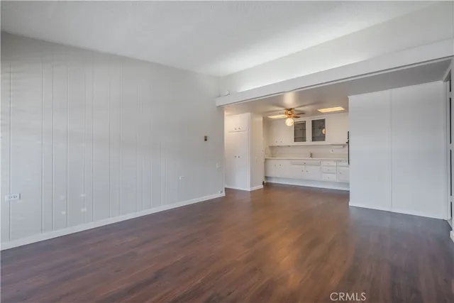 a kitchen with granite countertop white cabinets white stainless steel appliances and a sink