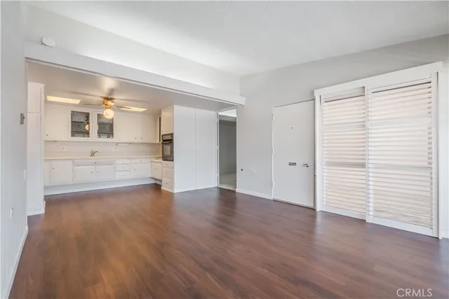a kitchen with white cabinets and sink