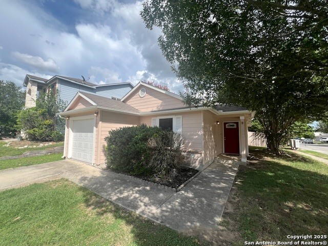 a front view of house with yard and green space