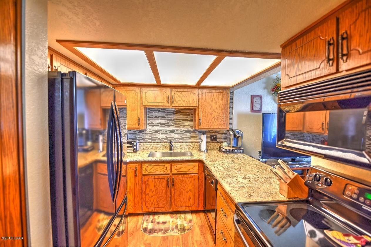 8625 Riverside Drive, Unit 72 Parker, AZ 85344 - Photo 6 of 24 Newly remodeled kitchen with granite counter tops and backsplash, farm sink and new faucet and garbage disposal