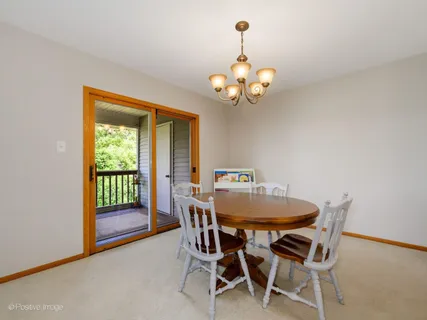a view of a dining room with furniture wooden floor and chandelier