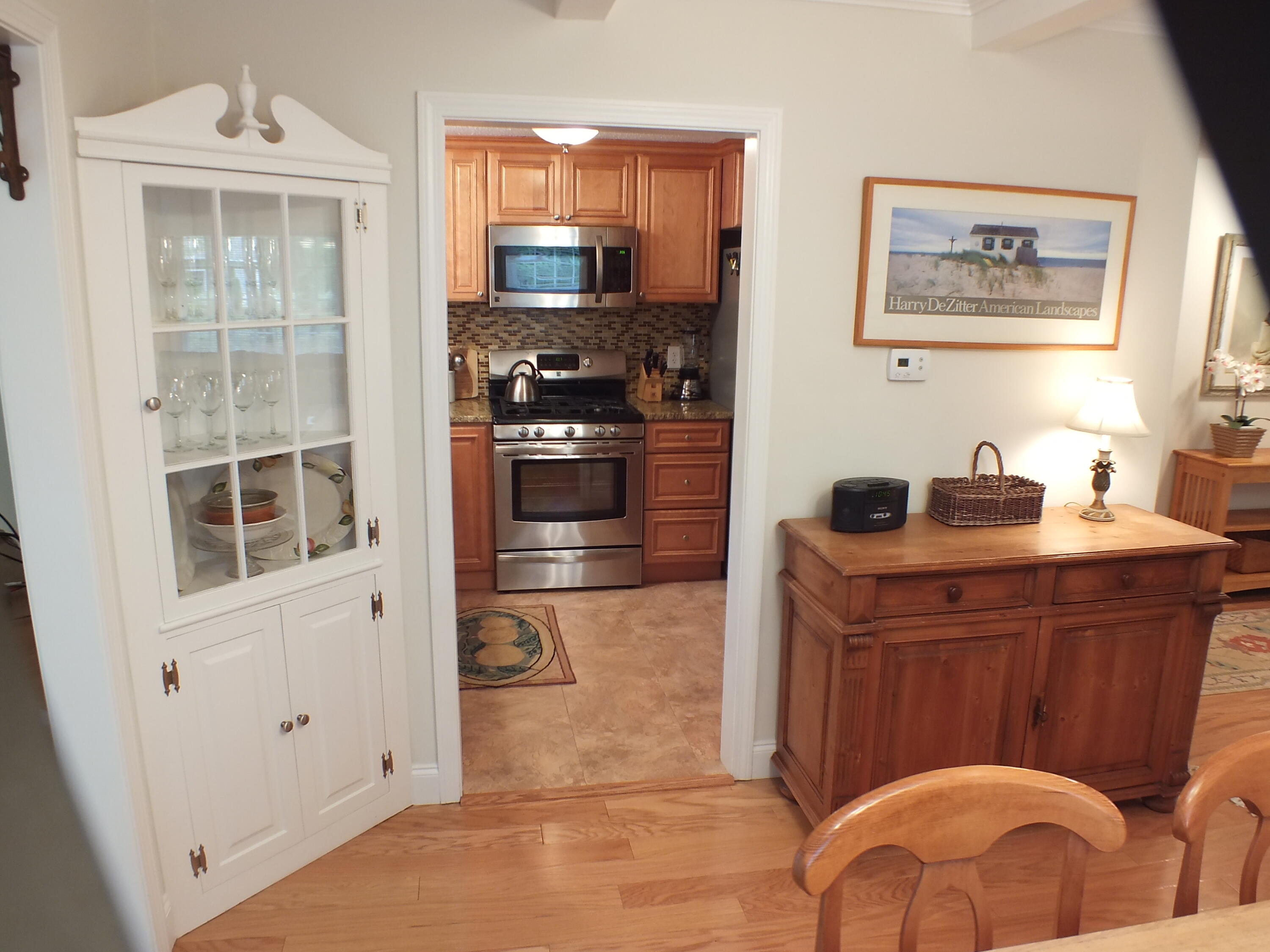 5 Amos Landing Road Mashpee, MA 02649 - Photo 15 of 27 a kitchen with stainless steel appliances granite countertop a refrigerator a stove and a sink with wooden floor