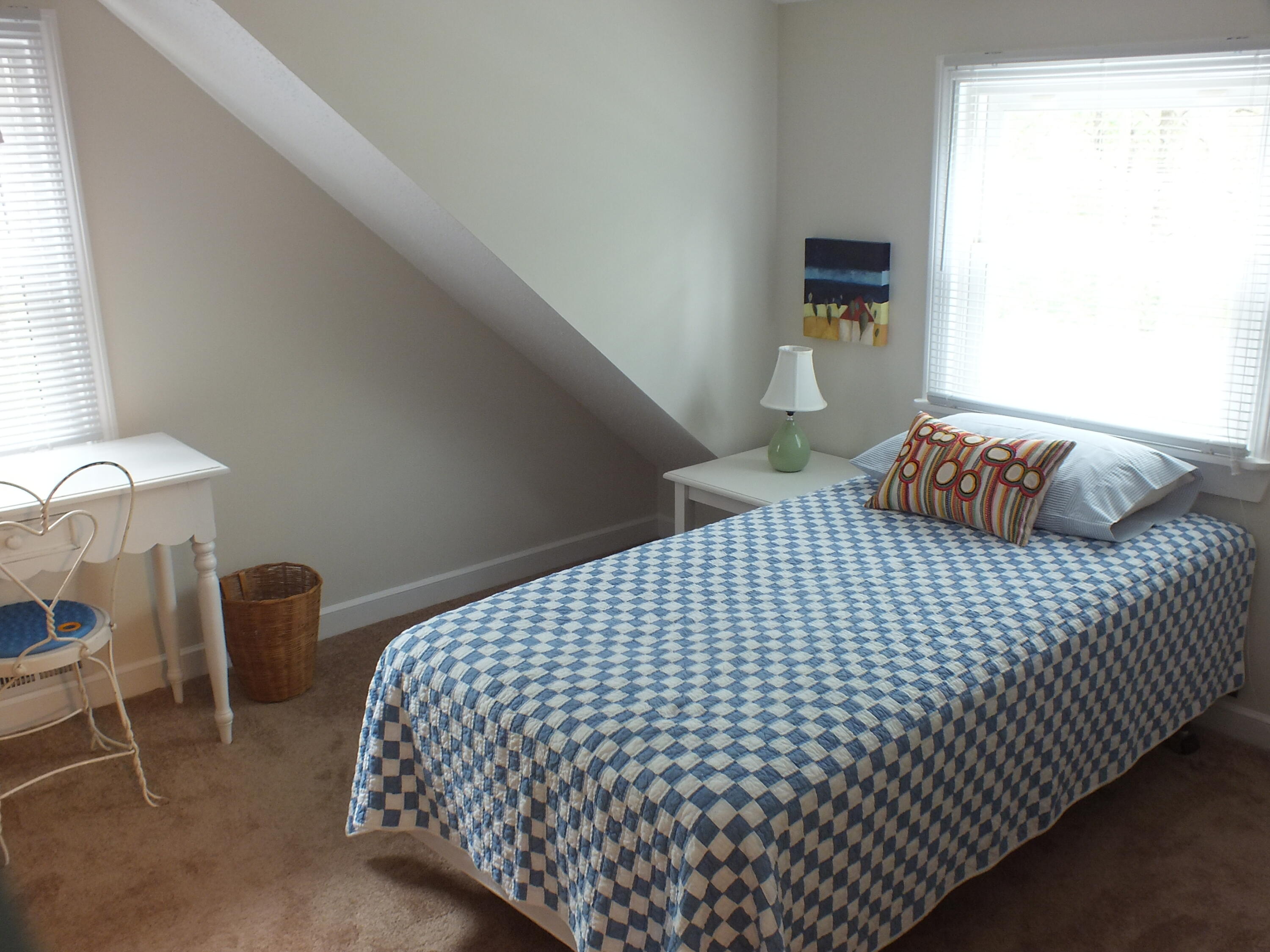 5 Amos Landing Road Mashpee, MA 02649 - Photo 22 of 27 a bedroom with a bed and chair