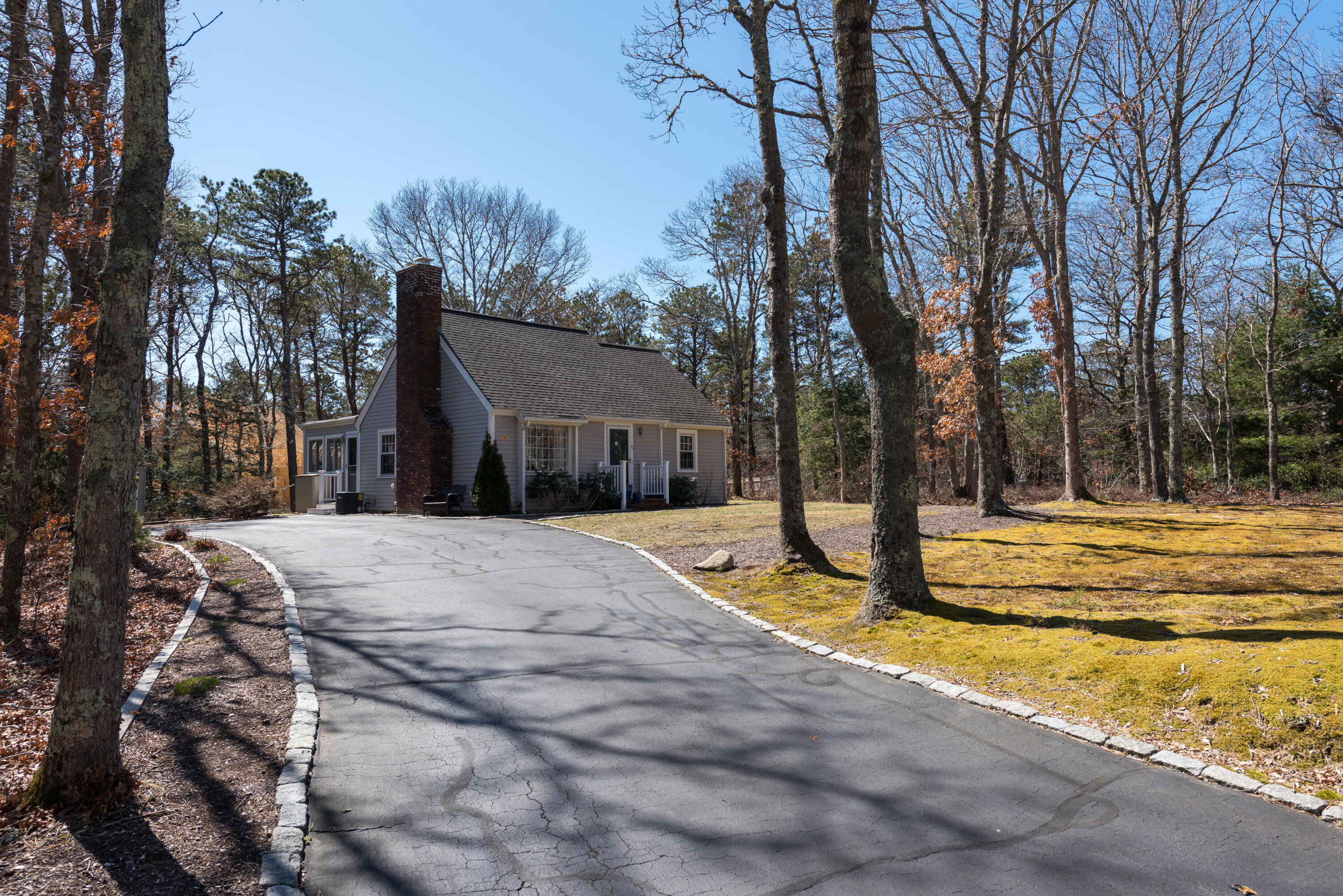 5 Amos Landing Road Mashpee, MA 02649 - Photo 3 of 27 a house with trees in front of it