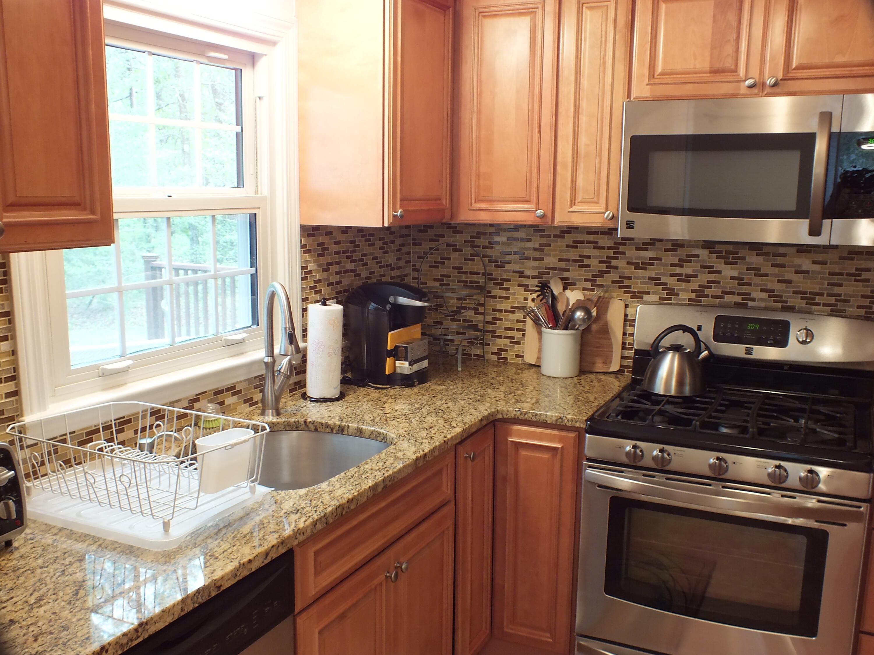 5 Amos Landing Road Mashpee, MA 02649 - Photo 10 of 27 a kitchen with granite countertop a sink stainless steel appliances and cabinets