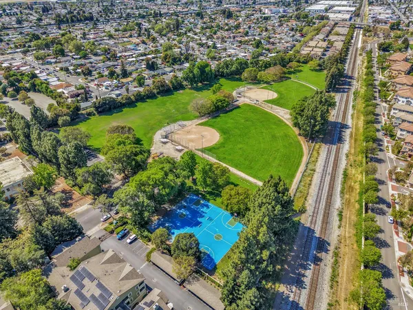 an aerial view of a residential houses with outdoor space and street view