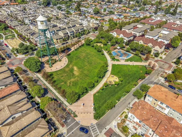 an aerial view of a residential houses with yard
