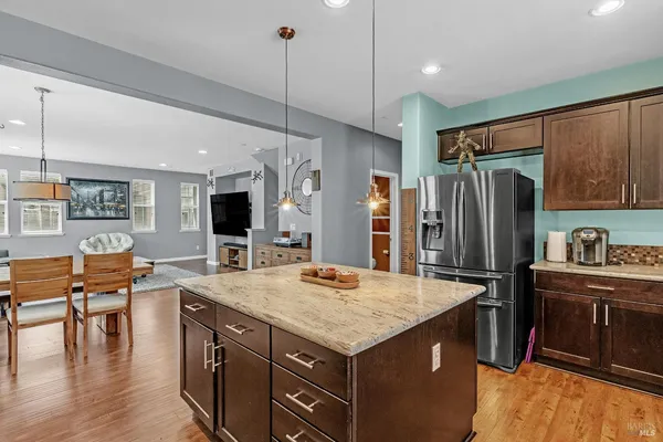 a living room with furniture a window and a clock