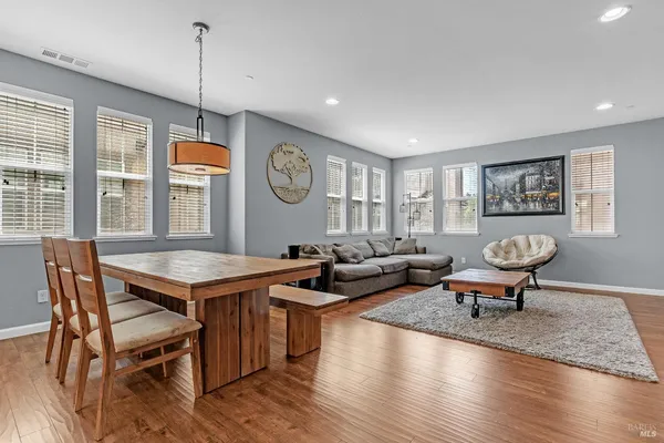 a living room with furniture a window and wooden floor