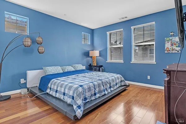 a bedroom with a bed and a flat screen tv