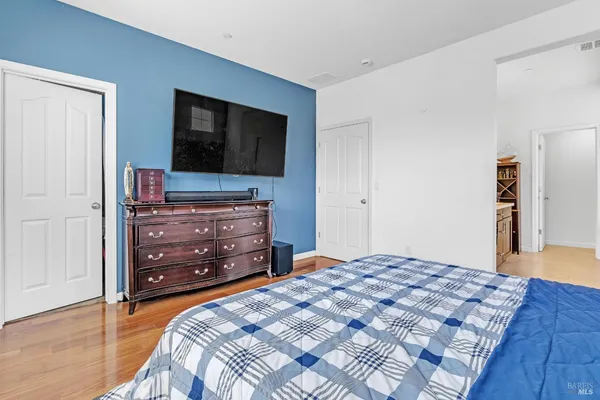 a hallway with cabinets and wooden floor