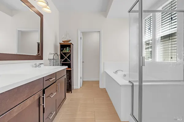 a bathroom with a tub a sink and shower