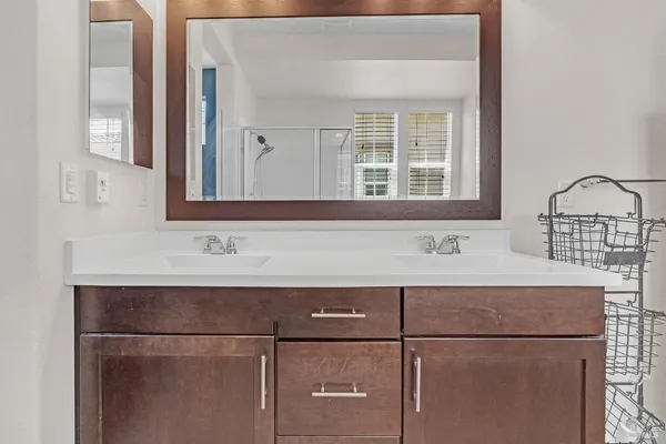 a bathroom with a tub sink and mirror