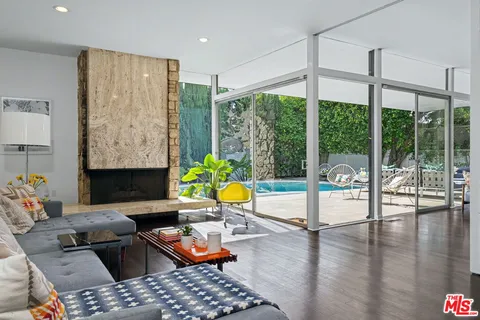 a view of a living room and floor to ceiling window or wooden floor