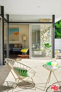 a view of swimming pool with outdoor seating and garden