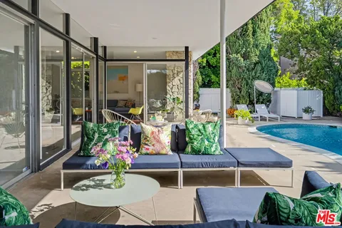 a view of a swimming pool with an outdoor seating
