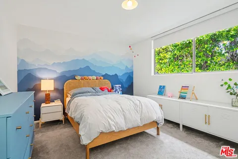 a bed room with a bed and a chair