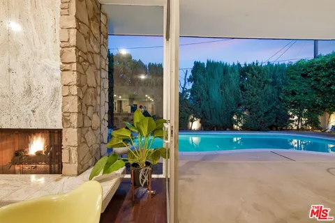 a patio with swimming pool table and chairs