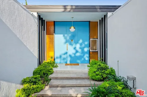 a front view of a house with a garden