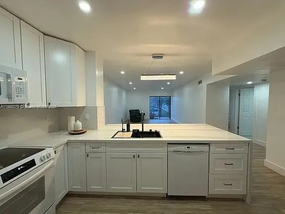 a kitchen with a sink and cabinets