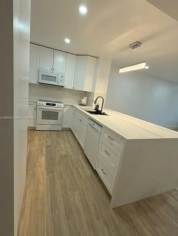 1800 West 54th Street, Unit 105 Hialeah, FL 33012 - Photo 12 of 59 a kitchen with wooden cabinets and a sink