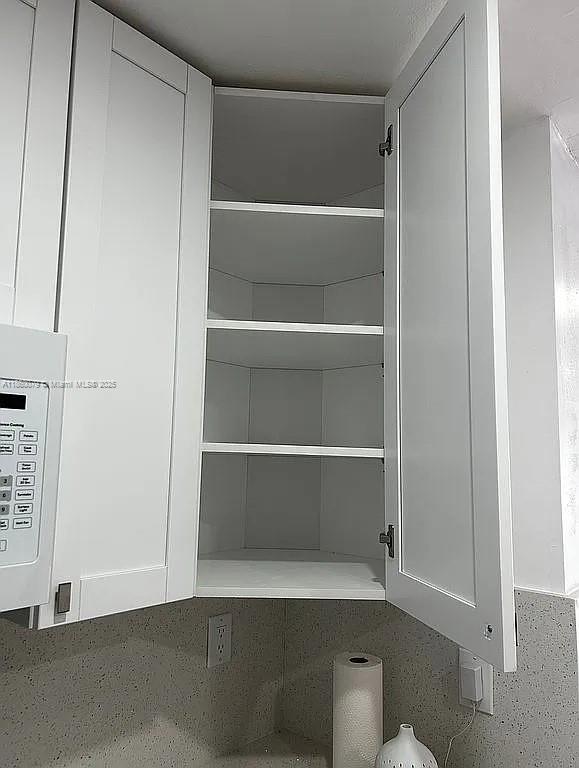 1800 West 54th Street, Unit 105 Hialeah, FL 33012 - Photo 23 of 59 a view of walk in closet with empty racks