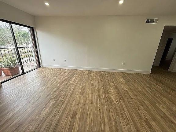 1800 West 54th Street, Unit 105 Hialeah, FL 33012 - Photo 28 of 59 wooden floor in an empty room with a window