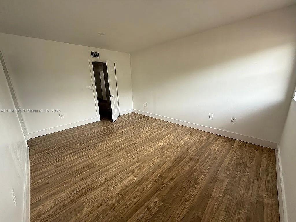 1800 West 54th Street, Unit 105 Hialeah, FL 33012 - Photo 32 of 59 a view of empty room with wooden floor
