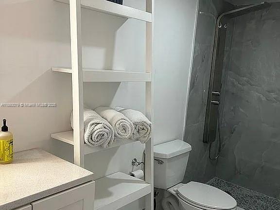1800 West 54th Street, Unit 105 Hialeah, FL 33012 - Photo 34 of 59 a white toilet sitting next to a bathroom sink