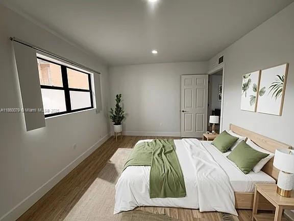 1800 West 54th Street, Unit 105 Hialeah, FL 33012 - Photo 40 of 59 a bed sitting in a bedroom next to a window