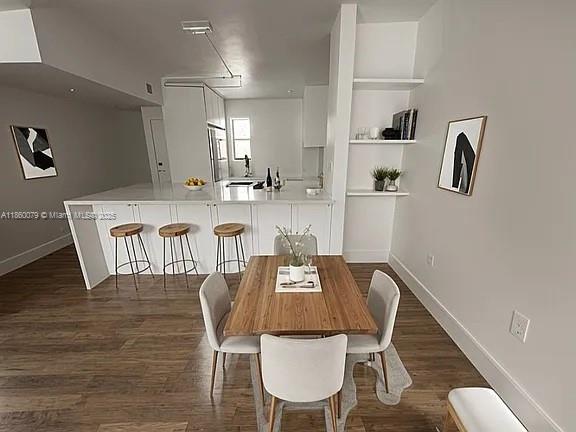 1800 West 54th Street, Unit 105 Hialeah, FL 33012 - Photo 5 of 59 a view of a dining room with furniture and wooden floor