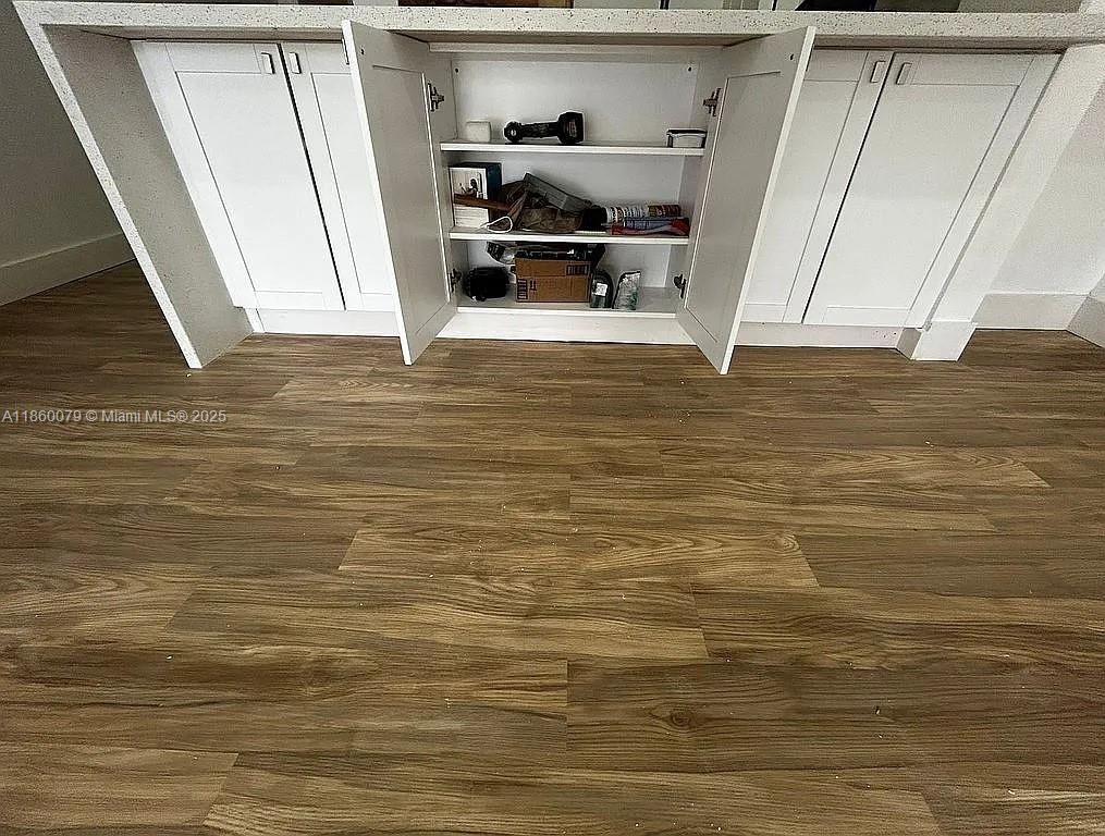 1800 West 54th Street, Unit 105 Hialeah, FL 33012 - Photo 6 of 59 a view of walk in closet with clothes and shoes