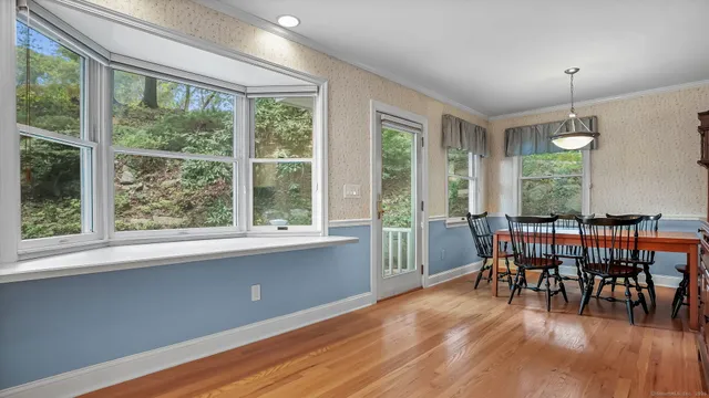 a view of a dining room with furniture window and wooden floor