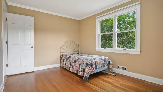 a bedroom with a bed and a window