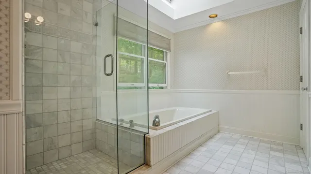 a bathroom with a granite countertop sink a mirror and a shower